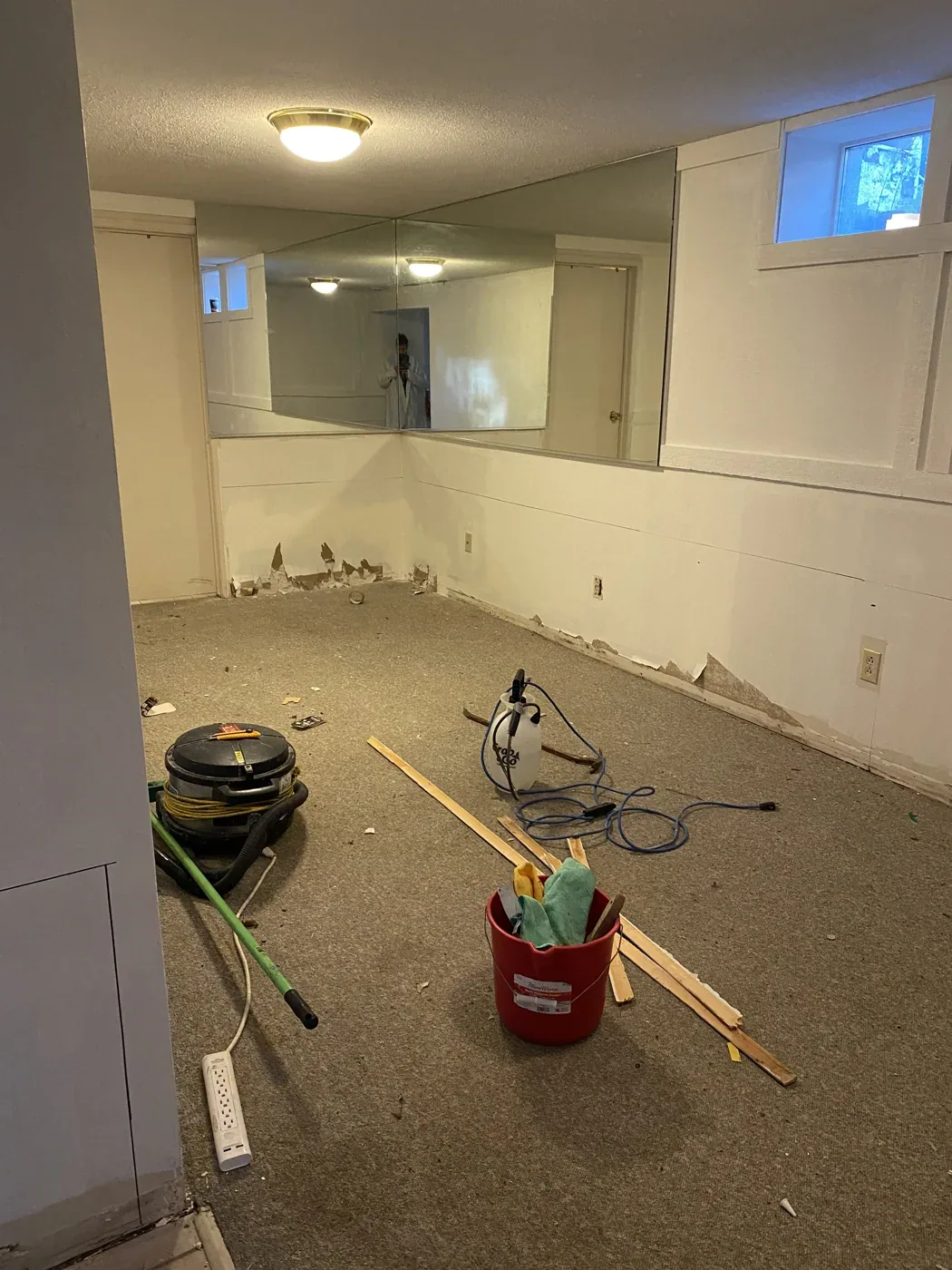 Room before water-damaged drywall removal